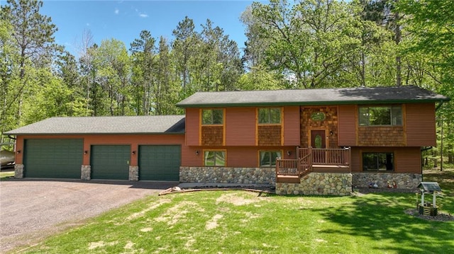 3015 Aspen Ter, Danbury, WI 54830 - raised ranch featuring asphalt driveway, stone siding, an attached garage, and a front yard