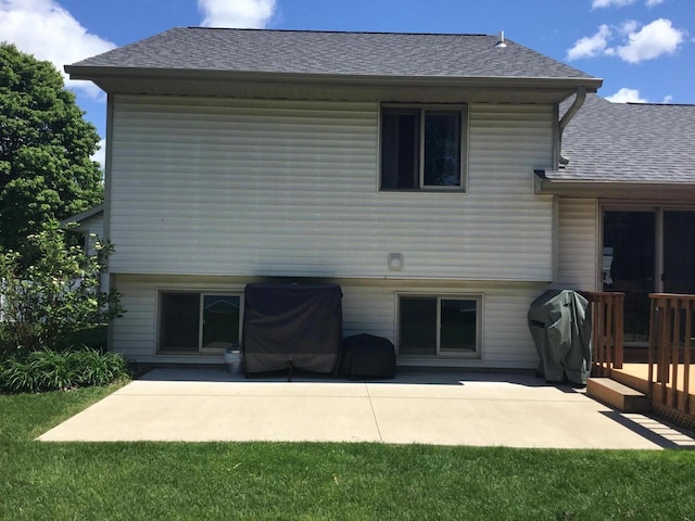 2706 Pleasant Dr, Holmen, WI 54636 - back of property with a shingled roof, a patio area, and a deck