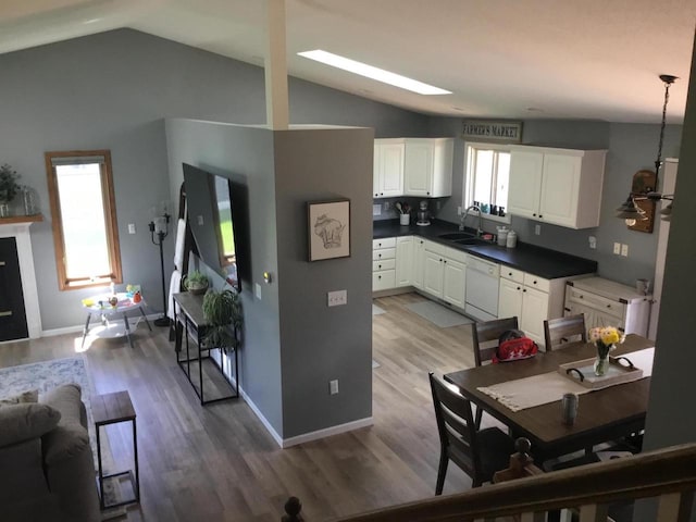 2706 Pleasant Dr, Holmen, WI 54636 - kitchen with a sink, lofted ceiling, dishwasher, wood finished floors, and white cabinetry