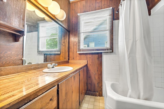 2301 W High St, Racine, WI 53404 - full bathroom with wooden walls, vanity, and shower / bath combo