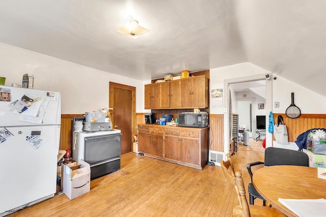 2301 W High St, Racine, WI 53404 - kitchen featuring freestanding refrigerator, range, brown cabinetry, light wood-type flooring, and lofted ceiling