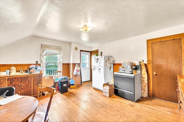 2301 W High St, Racine, WI 53404 - kitchen with freestanding refrigerator, range with electric cooktop, light wood finished floors, wainscoting, and brown cabinetry