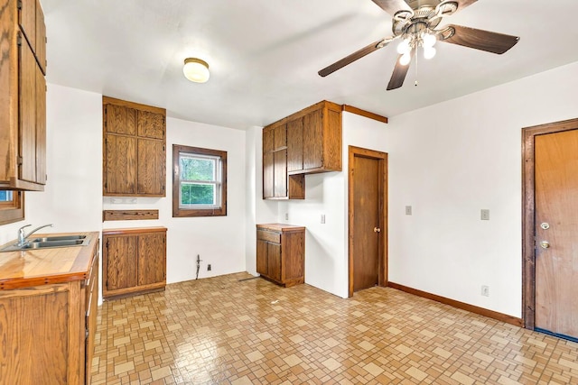 2301 W High St, Racine, WI 53404 - kitchen with a sink, brown cabinetry, and light countertops