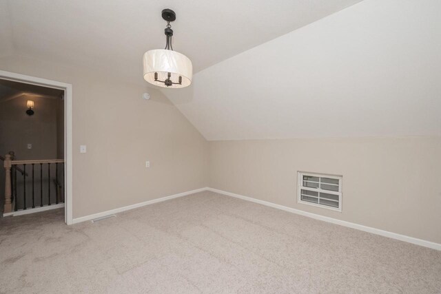 301 Maple Ave, Clinton, WI 53525 - additional living space with vaulted ceiling, carpet floors, and baseboards