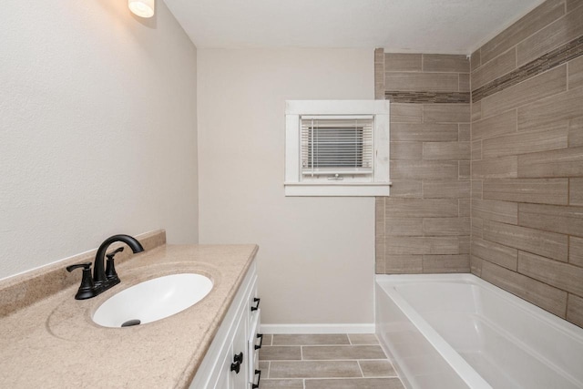 301 Maple Ave, Clinton, WI 53525 - full bath featuring a bathtub, vanity, tile patterned flooring, and baseboards