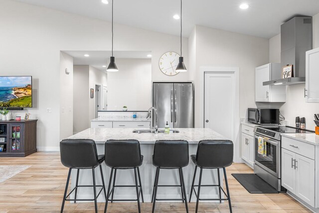 420 Sandmar Dr, Ripon, WI 54971 - kitchen featuring appliances with stainless steel finishes, a sink, a center island with sink, light wood-style floors, and lofted ceiling