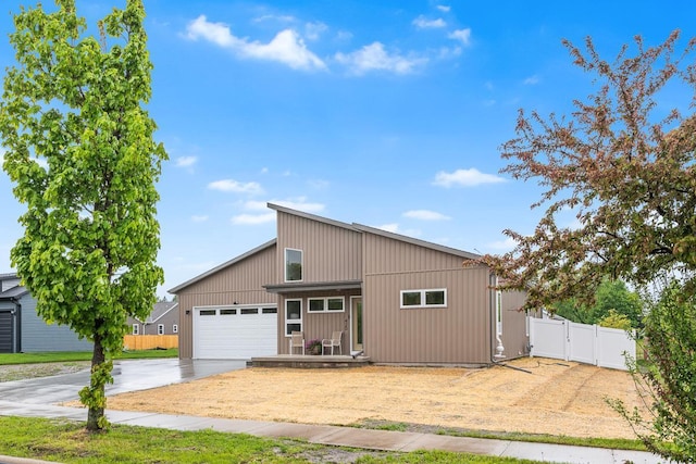 420 Sandmar Dr, Ripon, WI 54971 - mid-century modern home featuring driveway, an attached garage, and a gate