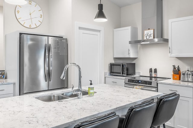 420 Sandmar Dr, Ripon, WI 54971 - kitchen with wall chimney exhaust hood, appliances with stainless steel finishes, white cabinets, a sink, and a kitchen bar