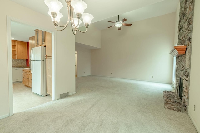 1 Winterberry Trl, Madison, WI 53717 - unfurnished living room featuring light colored carpet, a stone fireplace, a ceiling fan, a chandelier, and high vaulted ceiling