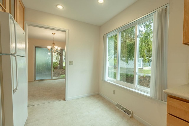 1 Winterberry Trl, Madison, WI 53717 - unfurnished dining area with healthy amount of natural light, a chandelier, recessed lighting, baseboards, and light colored carpet