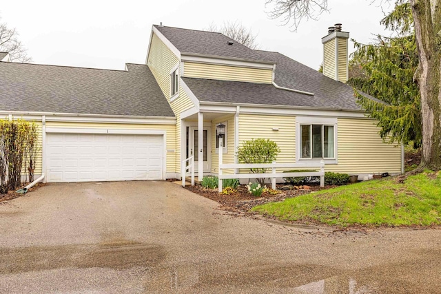 1 Winterberry Trl, Madison, WI 53717 - view of front facade with asphalt driveway, an attached garage, a chimney, and roof with shingles