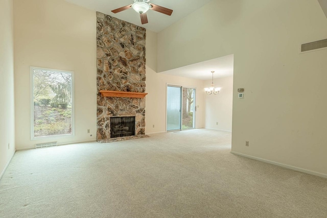 1 Winterberry Trl, Madison, WI 53717 - unfurnished living room with a chandelier, ceiling fan, a high ceiling, a fireplace, and carpet floors