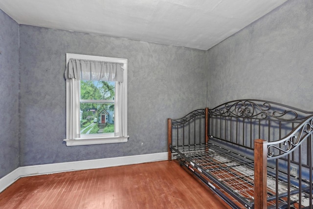 1525 N 69th St, Wauwatosa, WI 53213 - unfurnished bedroom featuring wood finished floors and baseboards