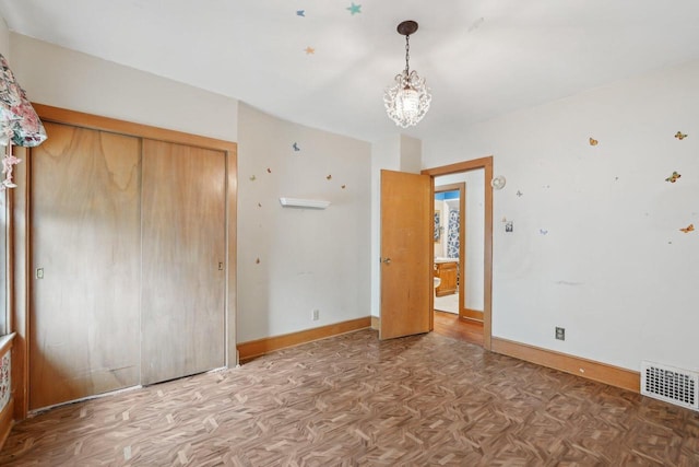 1525 N 69th St, Wauwatosa, WI 53213 - unfurnished bedroom with a chandelier, a closet, and baseboards