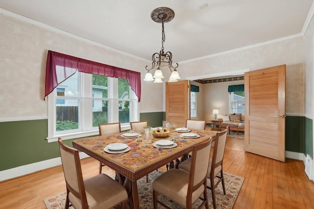 1525 N 69th St, Wauwatosa, WI 53213 - dining space featuring a chandelier, light wood finished floors, baseboards, and ornamental molding