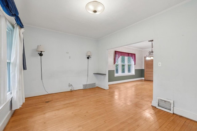 1525 N 69th St, Wauwatosa, WI 53213 - empty room featuring ornamental molding, hardwood / wood-style flooring, a chandelier, and baseboards