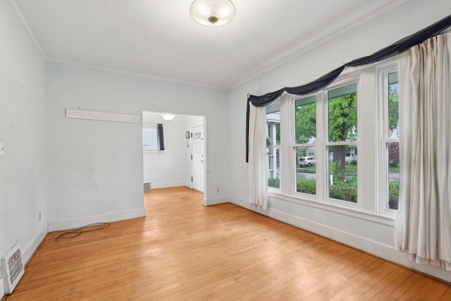 1525 N 69th St, Wauwatosa, WI 53213 - unfurnished room featuring crown molding, light wood-style flooring, and baseboards