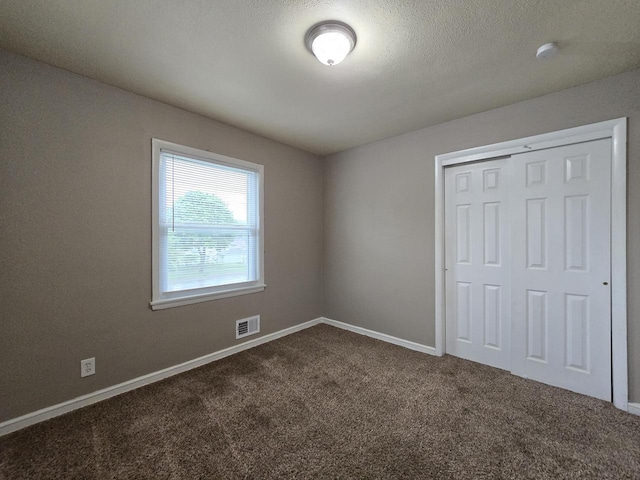 6229 W Keefe Avenue Parkway Unit 6229A, Milwaukee, WI 53216 - unfurnished bedroom featuring dark colored carpet, a closet, and baseboards