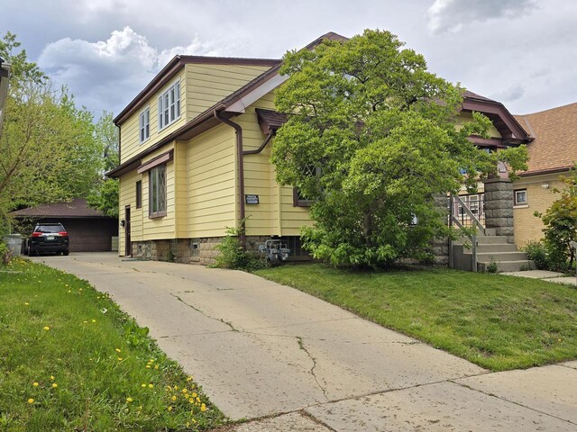 2931 N 58th St, Milwaukee, WI 53210 - view of property exterior with a yard and an outdoor structure