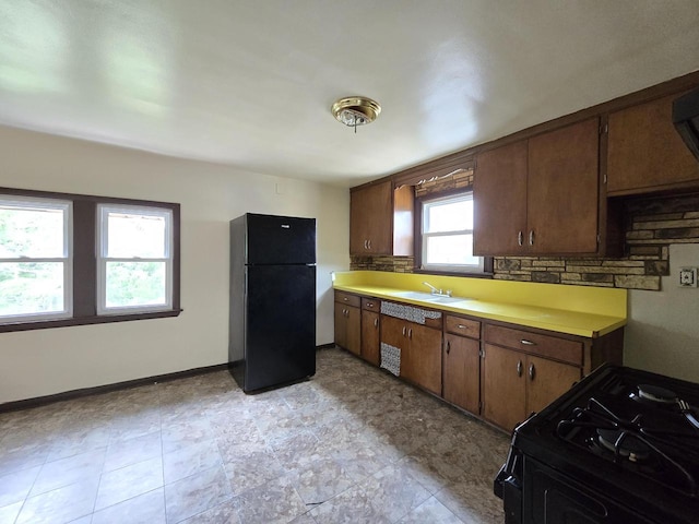 2931 N 58th St, Milwaukee, WI 53210 - kitchen featuring black appliances, light countertops, a sink, baseboards, and backsplash