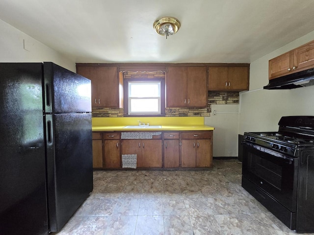 2931 N 58th St, Milwaukee, WI 53210 - kitchen featuring black appliances, under cabinet range hood, light countertops, and a sink