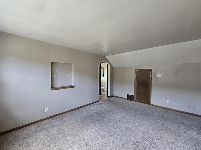 2931 N 58th St, Milwaukee, WI 53210 - carpeted empty room with baseboards, arched walkways, and vaulted ceiling