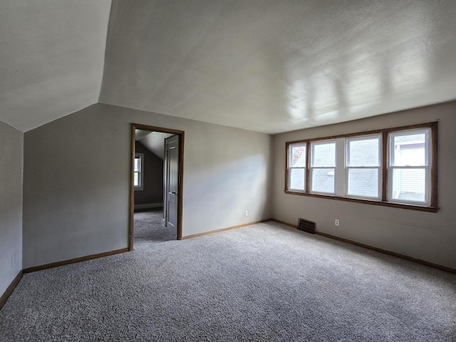 2931 N 58th St, Milwaukee, WI 53210 - unfurnished room featuring carpet flooring, baseboards, and vaulted ceiling