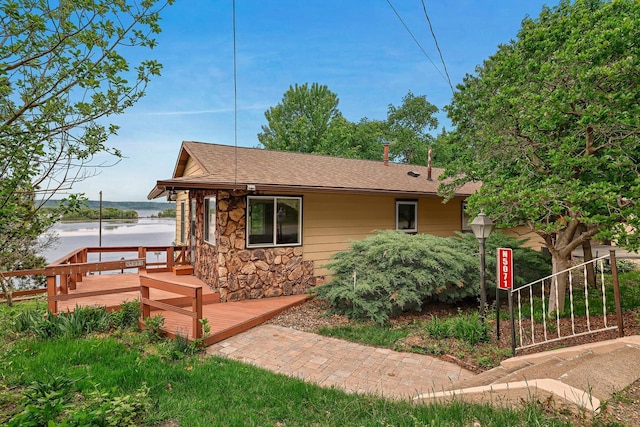 N5071 Sunset Vista Rd, Onalaska, WI 54650 - view of front of house with stone siding, a deck, and a shingled roof