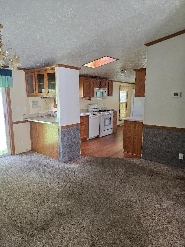 2942 Brentwood Dr, Grand Marsh, WI 53936 - kitchen featuring white appliances, dark carpet, brown cabinets, a textured ceiling, and glass insert cabinets