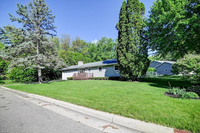 1610 Woodsend Ct, Sun Prairie, WI 53590 - ranch-style home with an attached garage, a front yard, a wooden deck, and a chimney