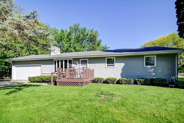 1610 Woodsend Ct, Sun Prairie, WI 53590 - rear view of house featuring an attached garage, a chimney, a wooden deck, a yard, and driveway