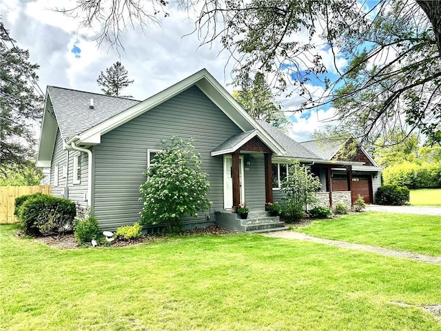 1019 2nd St, Bruce, WI 54819 - view of front facade with a shingled roof, a garage, and driveway