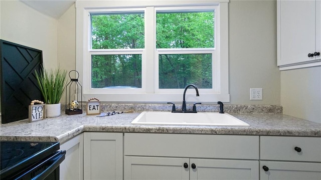 2572 90th St, Eau Claire, WI 54703 - kitchen with a sink, plenty of natural light, white cabinetry, and light countertops