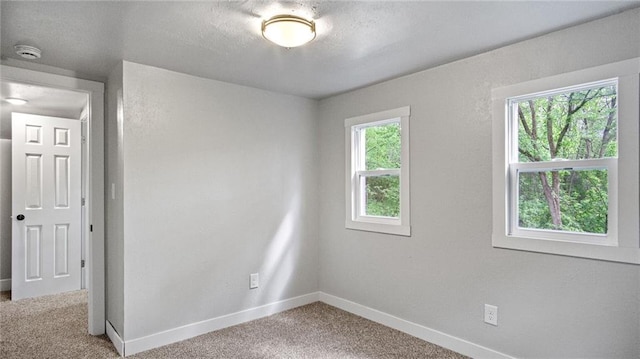 2572 90th St, Eau Claire, WI 54703 - spare room with light colored carpet, a smoke detector, and baseboards