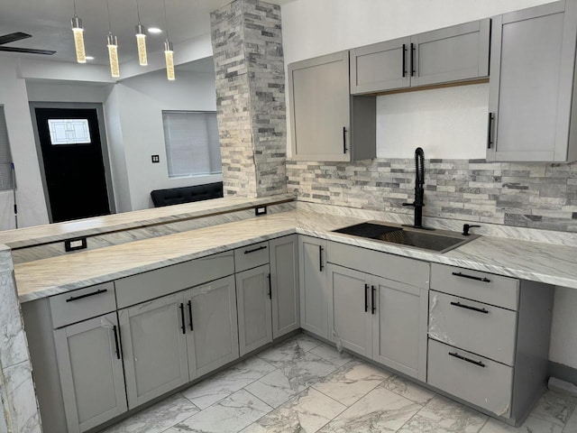 3124 N Buffum St, Milwaukee, WI 53212 - kitchen with gray cabinetry, a sink, light marble finish flooring, and a peninsula