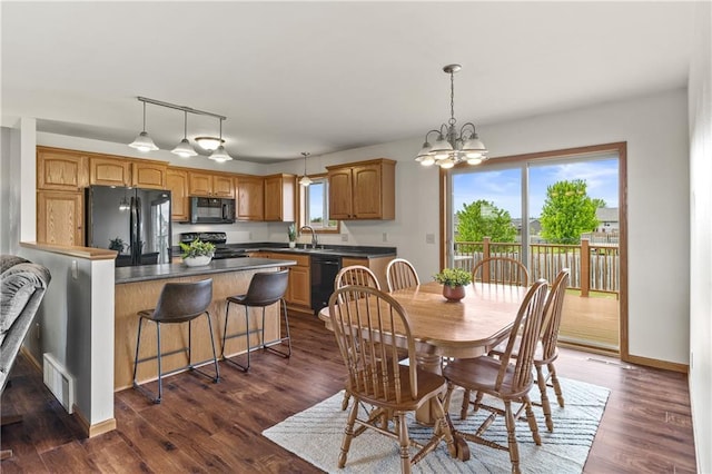 11684 44th Ave, Chippewa Falls, WI 54729 - dining area with dark wood-style floors, a chandelier, and baseboards