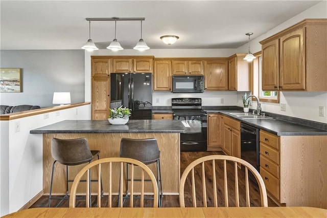 11684 44th Ave, Chippewa Falls, WI 54729 - kitchen with black appliances, a sink, dark countertops, a kitchen breakfast bar, and decorative light fixtures