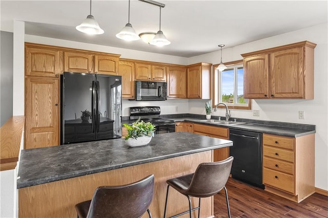 11684 44th Ave, Chippewa Falls, WI 54729 - kitchen with black appliances, a sink, a breakfast bar, dark wood-type flooring, and dark countertops