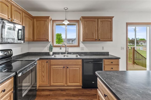 11684 44th Ave, Chippewa Falls, WI 54729 - kitchen featuring black appliances, a sink, dark countertops, and dark wood finished floors
