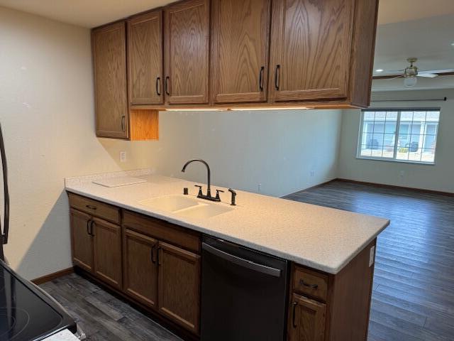1329 S Wilson Ave, Hartford, WI 53027 - kitchen featuring dishwasher, a sink, dark wood-style floors, light countertops, and ceiling fan