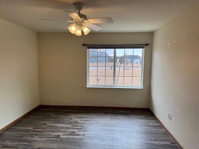 1329 S Wilson Ave, Hartford, WI 53027 - spare room with wood finished floors, ceiling fan, and baseboards