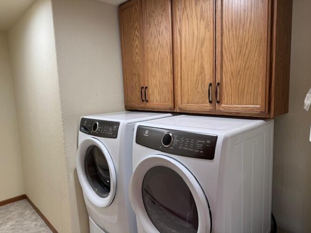 1329 S Wilson Ave, Hartford, WI 53027 - washroom featuring washer and clothes dryer, cabinet space, and baseboards