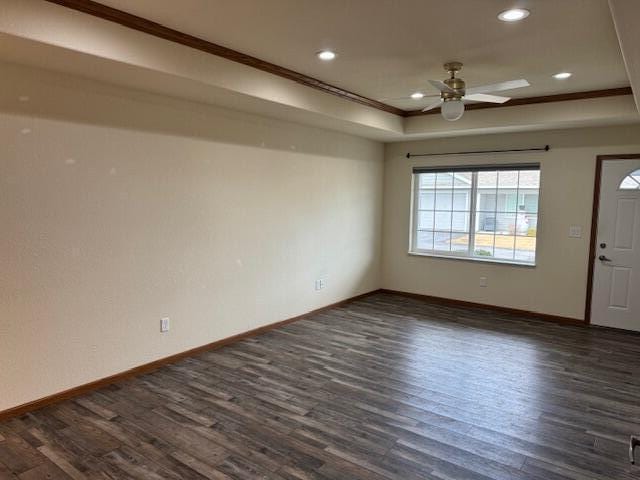 1329 S Wilson Ave, Hartford, WI 53027 - empty room with ceiling fan, dark wood finished floors, a tray ceiling, baseboards, and recessed lighting