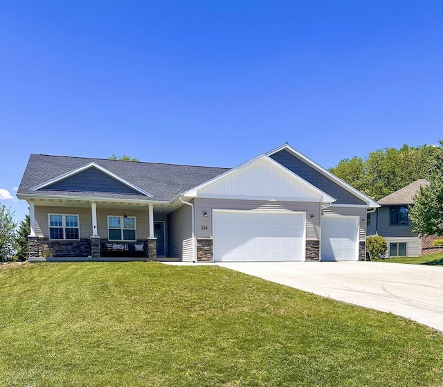 224 Clover Ln, Janesville, WI 53537 - craftsman inspired home with stone siding, a front yard, a garage, and driveway