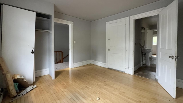 5410 N 37th St, Milwaukee, WI 53209 - unfurnished bedroom with light wood finished floors, a closet, and baseboards