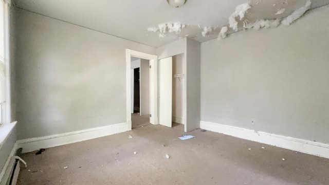 5410 N 37th St, Milwaukee, WI 53209 - unfurnished bedroom featuring a closet, baseboards, and a baseboard radiator