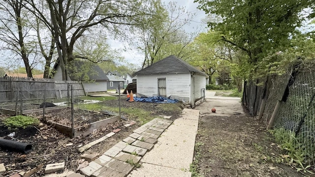 5410 N 37th St, Milwaukee, WI 53209 - view of yard featuring a vegetable garden and an outbuilding