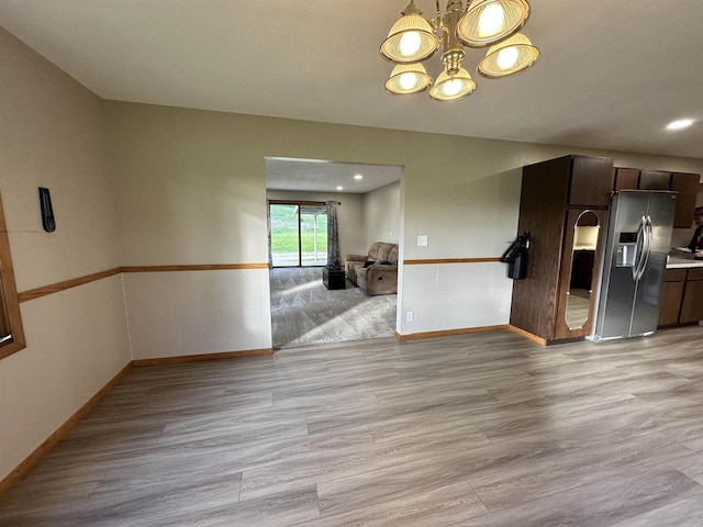 N2224 Wafle Rd, Mauston, WI 53948 - kitchen with stainless steel fridge with ice dispenser, light wood-style floors, a chandelier, baseboards, and open floor plan