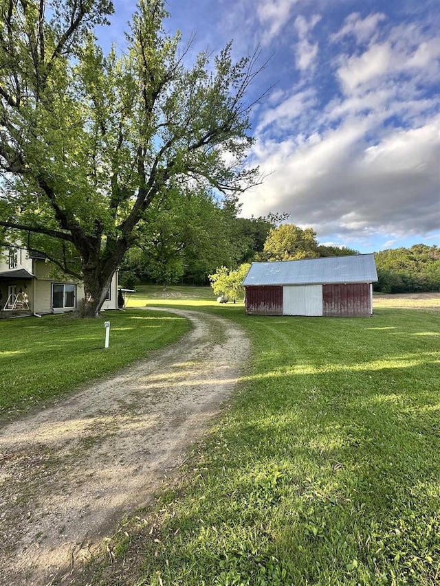 N2224 Wafle Rd, Mauston, WI 53948 - view of dirt / gravel driveway with a pole building