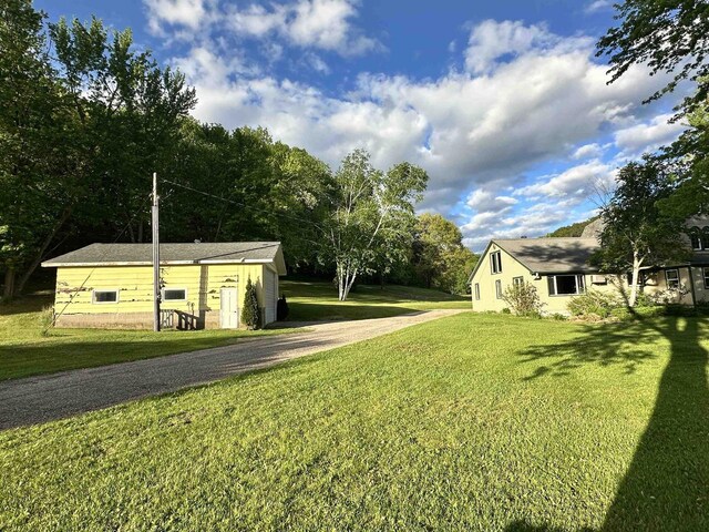 N2224 Wafle Rd, Mauston, WI 53948 - view of green lawn with driveway and an outbuilding